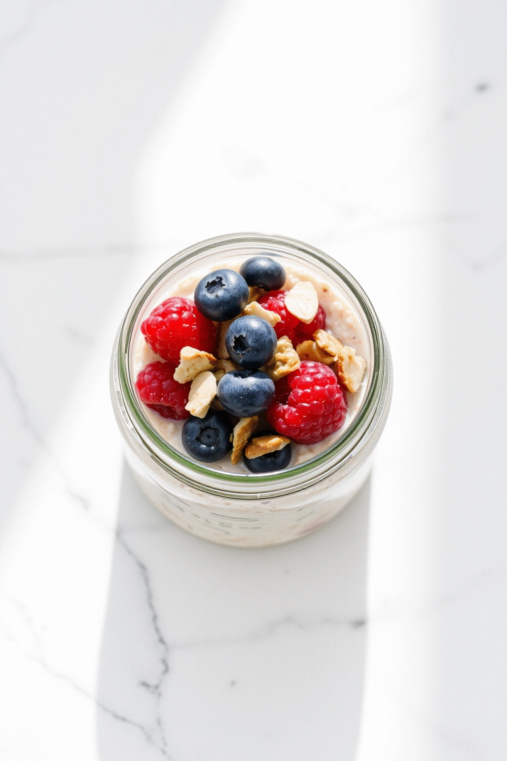 Overnight oats with fresh berries and nuts in a glass jar, perfectly layered and ready to eat, natural morning light, healthy and appetizing.